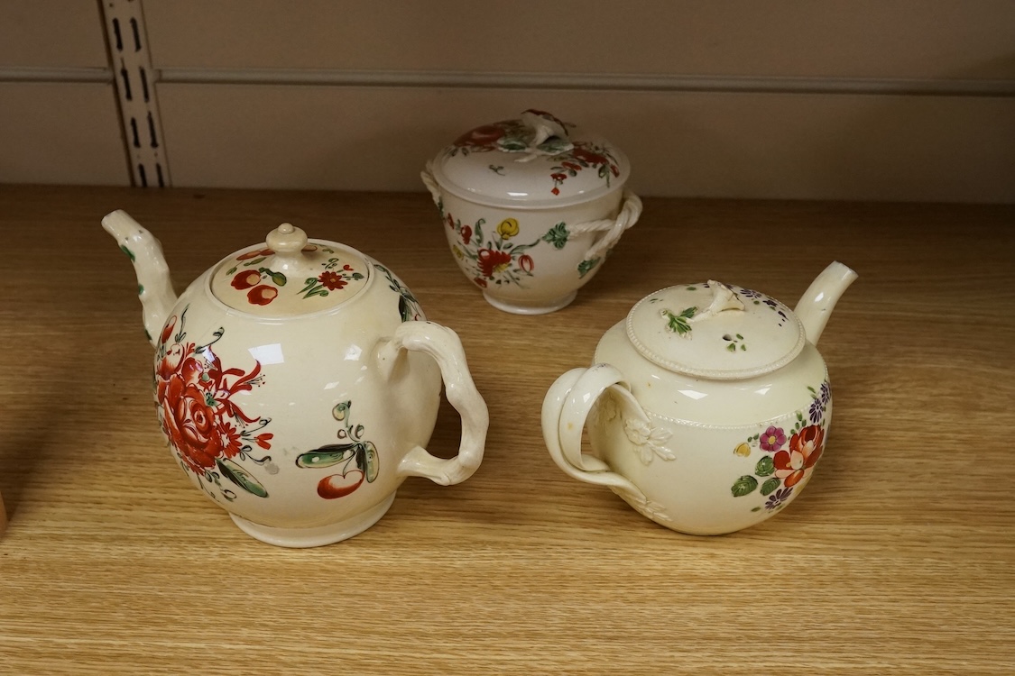 Two George III creamware teapots and a lidded sugar bowl, c.1780, largest 20cm wide